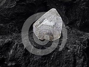 Diamond on black coal background