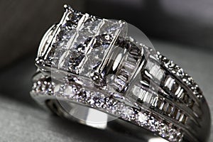 A diamond engagement ring .in a box with glint/reflection. Shimmering princess-cut diamonds.