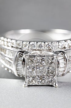 A diamond engagement ring .in a box with glint/reflection. Shimmering princess-cut diamonds.