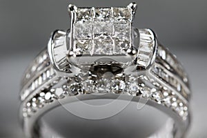 A diamond engagement ring. in a box with glint/reflection. Shimmering princess-cut diamonds.