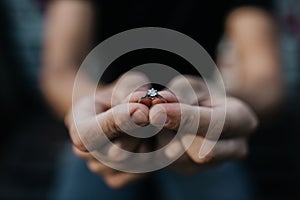 The diamond engagement ring in a hand