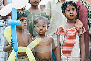 DIAMOND HARBOR, INDIA - MARCH 30: Poor rural indian children receive balloons from missionaries