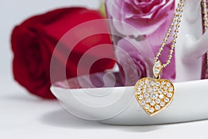 Diamond heart shape pendant and red rose