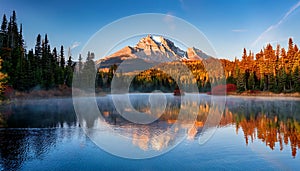 Diamond Lake in autumn with reflection of Rundle Mountain at sunrise