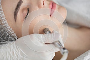 Diamond microdermabrasion, peeling cosmetic. woman during a microdermabrasion treatment