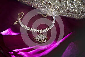 Diamond necklace placed on a red backdrop