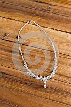 Diamond necklace on wooden background