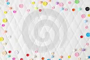 Diamond pattern paper texture with colorful buttons placed around