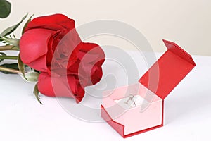 Diamond ring in box and red rose