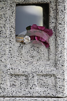 Diamond ring in granite window with flower