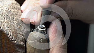 Diamond ring making. jeweler putting ring on ring close up. handmade diamond ring production.
