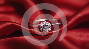 Diamond ring on the red silk background in focus.