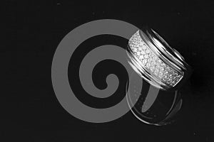 Diamond ring with reflection in isolated black bac