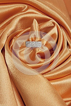 Diamond ring on silk background