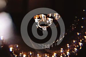 Diamond rings on black Chic wedding rings with diamonds on a black background with a light color effect.blue background with