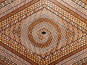 Diamond shaped geometric mosaic marquetry wooden surface.