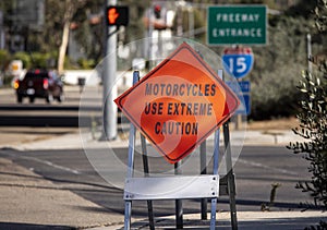 A diamond shaped road sign advising motorcyle riders to use extreme caution