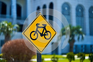 Diamond shaped sign with a bicycle. Alerting car drivers about a large number of cyclists