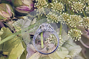 Diamond wedding engagement ring on natural romantic backgroun