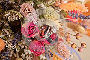 Diamond Wedding Ring with Wedding Band and Bouquet of Dried Wildflowers photo