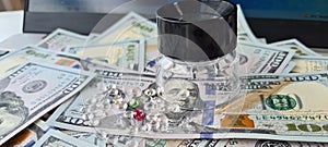Diamonds and gems on dollar bills with keyboard magnifier. Buying diamonds online and verifying authenticity