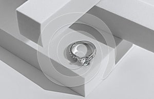 Diamonds ring on geometric white background with copy space