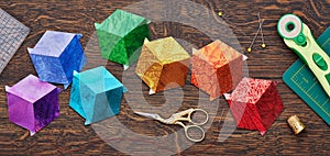 Diamonds stitched in the form of a cube in the colors of the rainbow, quilting and sewing accessories