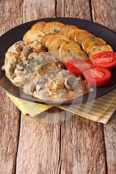 Diana steak with mushroom sauce and roasted potatoes close-up on