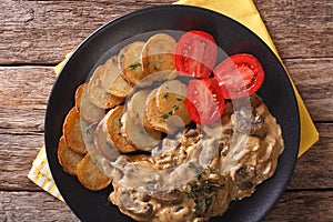 Diana steak with mushrooms and roasted potatoes close-up. Horizontal top view