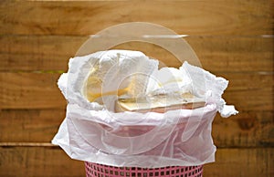 Diapers waste - dirty diapers in a garbage pail Disposing of used baby nappies photo