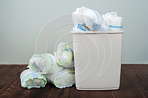 Diapers waste, dirty diapers in garbage pail Disposing of used baby nappies. Environmental Impact of Disposable Diapers. Pollution photo