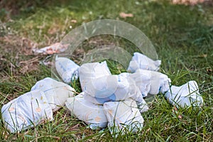 Diapers waste, dirty diapers in nature. Disposing of used baby nappies. Environmental Impact of Disposable Diapers. Pollution of