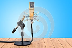 Diaphragm condenser studio microphone with shock-mount on the ta