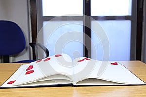 Diary with blank sheet and red flower petals