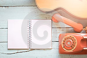 The diary blanks with retro telephone and acoustic guitar