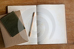 Diary book and pencil on wooden table