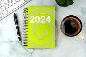 2024 Diary, pen and cup of coffee