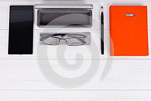 Diary with a pen, stylish glasses and open case for glasses near