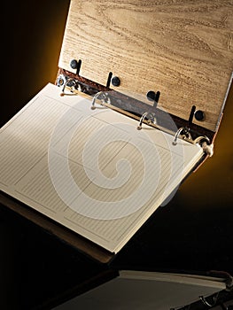 diary with a wooden cover open for writing a business plan