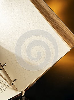 diary with a wooden cover open for writing a business plan