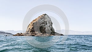 The Dibba Rock island in the Indian Ocean on the coast of the Gulf of Omman in the suburbs of the Sharjah city, United Arab