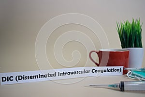 DIC  Disseminated Intravascular Coagulation text, grass pot, coffee cup, syringe, and face green mask.