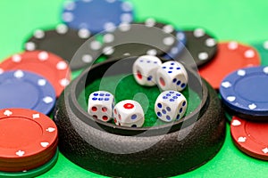 Dice and casino chips on green baize table
