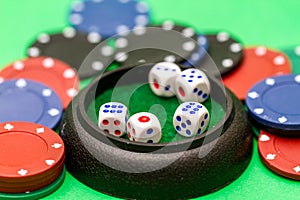 Dice and casino chips on green baize table