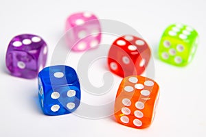 Dice of different colors isolated on a white background.