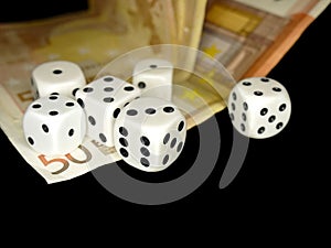 Dice and European banknotes money on black background, gambling