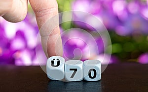 Dice form the German expression `UE 70` above 70 years old as symbol for people older than 70 years.