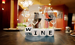 Dice form the words wine and dine in a restaurant.