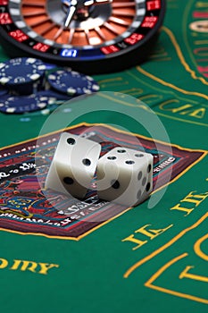 Dice on a gambling table with chips and cards for gambling