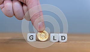 Dice and a Krugerrand coin form the word `GOLD`